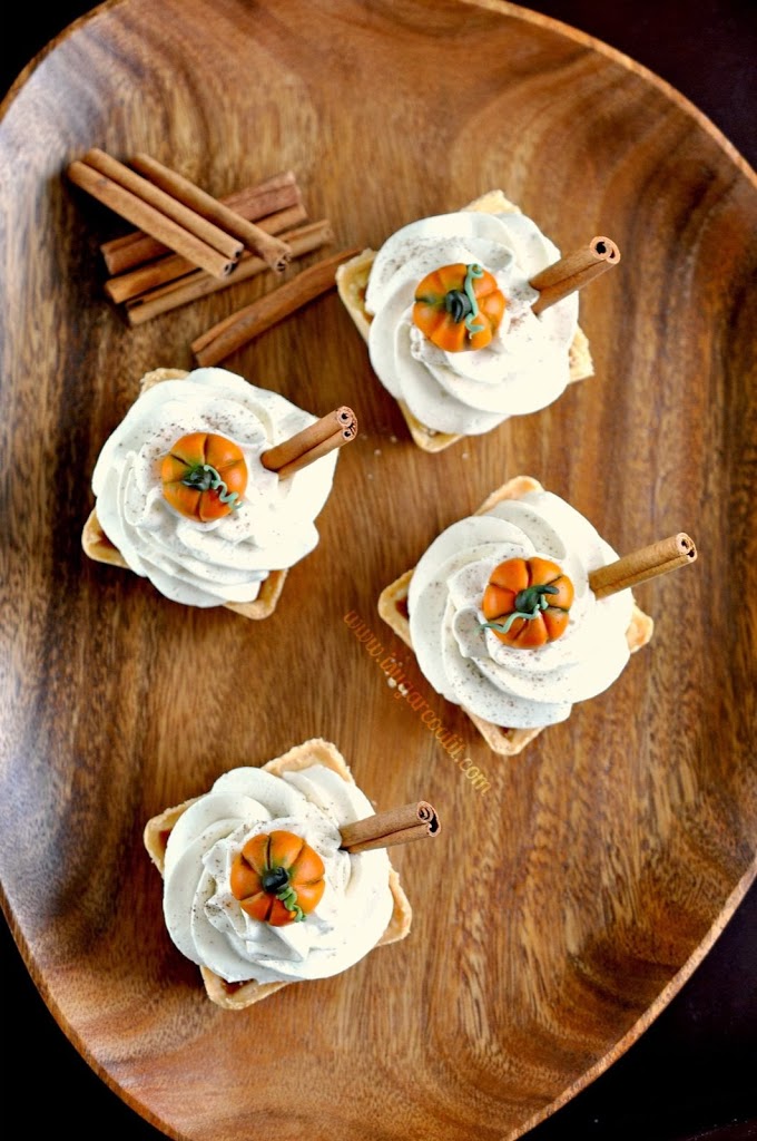 Mini Maple Chai Pumpkin Pies with Whipped Coconut, baked in a sweet pastry crust topped with fluffy clouds of coconut whipped cream!