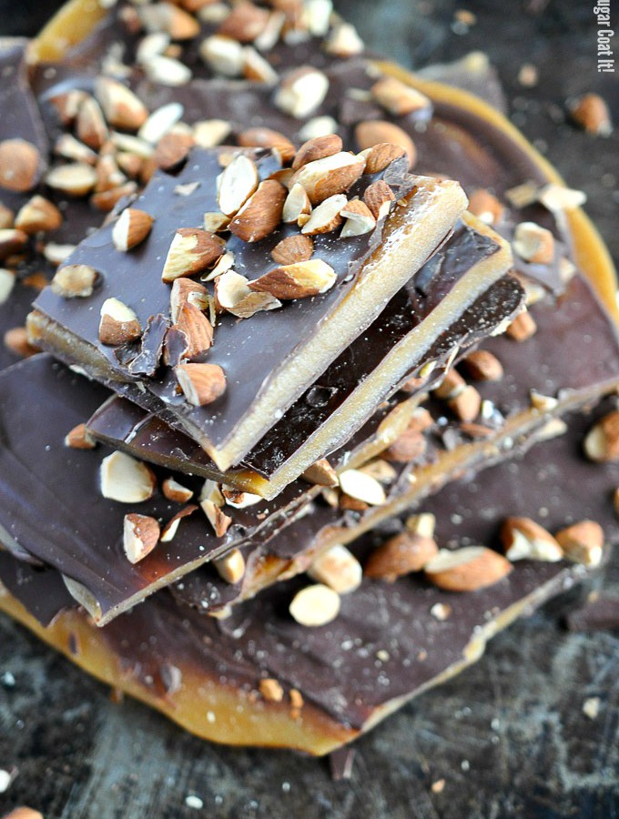 Almond English Toffee with homemade toffee sandwiched between thin layers of decadent dark chocolate and topped with roasted almonds.