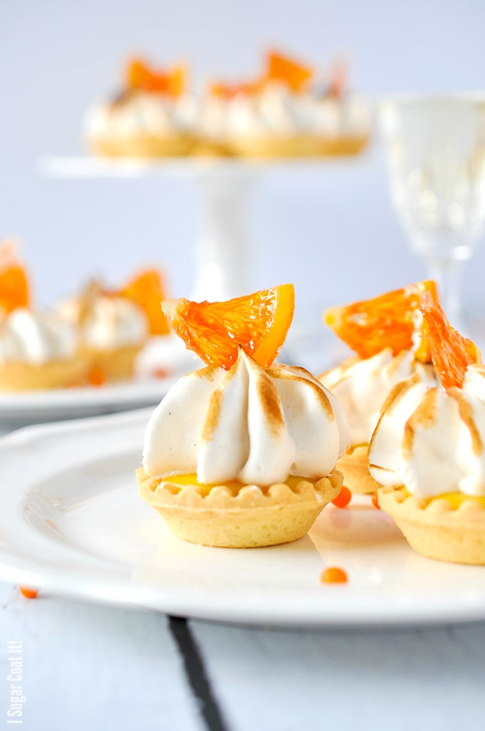 Candied Cara Cara Curd Meringue Tarts are mini bites of sweet, tangy, creamy sunshine topped with clouds of vanilla bean meringue and candied oranges.