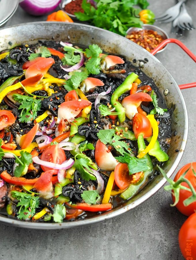 Seafood Paella Noir with Arctic Surf Clams, baby octopus, shrimps, Thai purple rice and a colourful array of vegetables and spices.