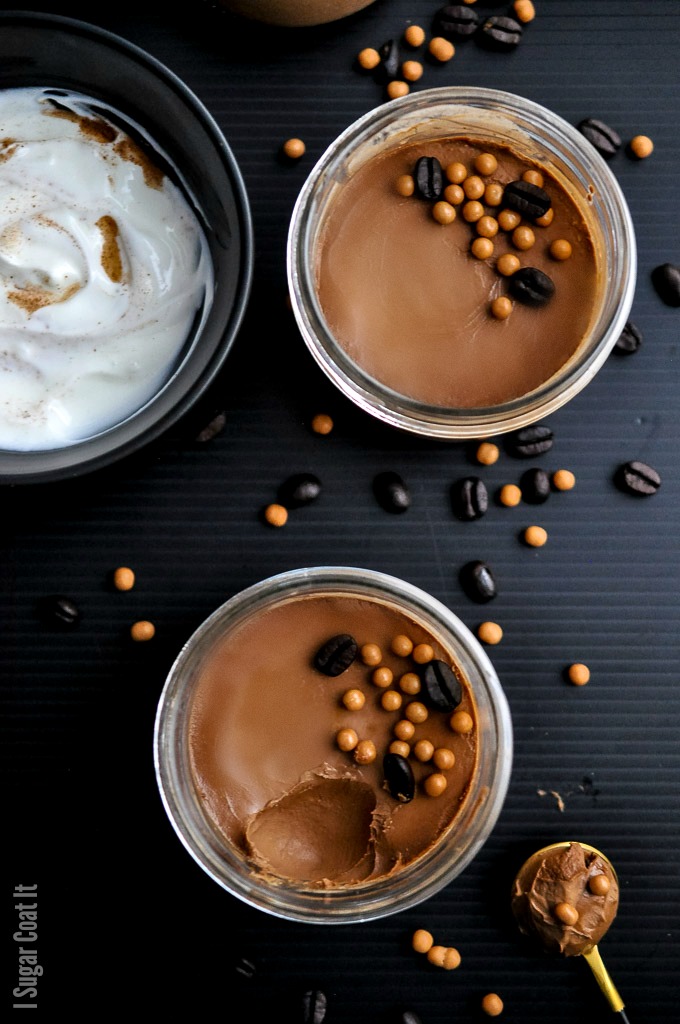 sous vide chocolate coffee pots de creme with chocolate coffee beans and crunch pearls on a black background. | i sugar coat it