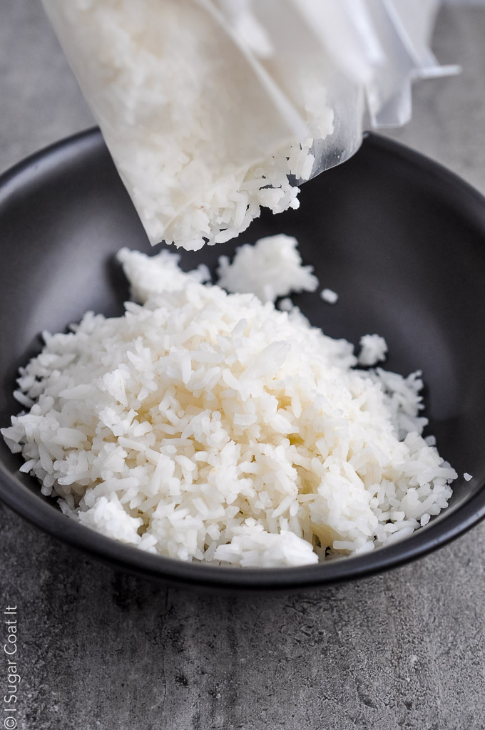 sous vide rice being poured from a vacuum bag into a black bowl | i sugar coat it